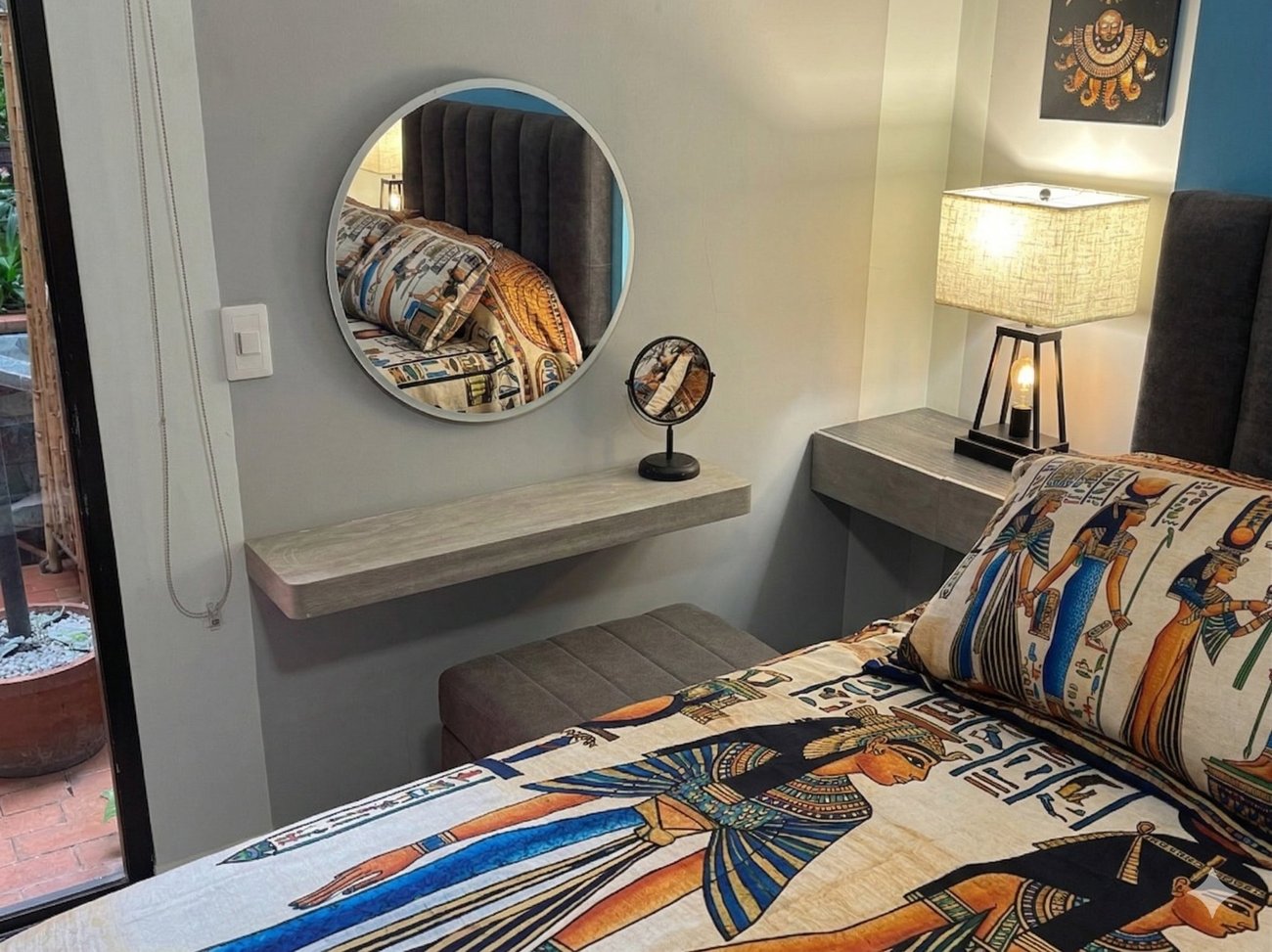 Bedroom vanity detail — pre-Columbian art and bedside lamp