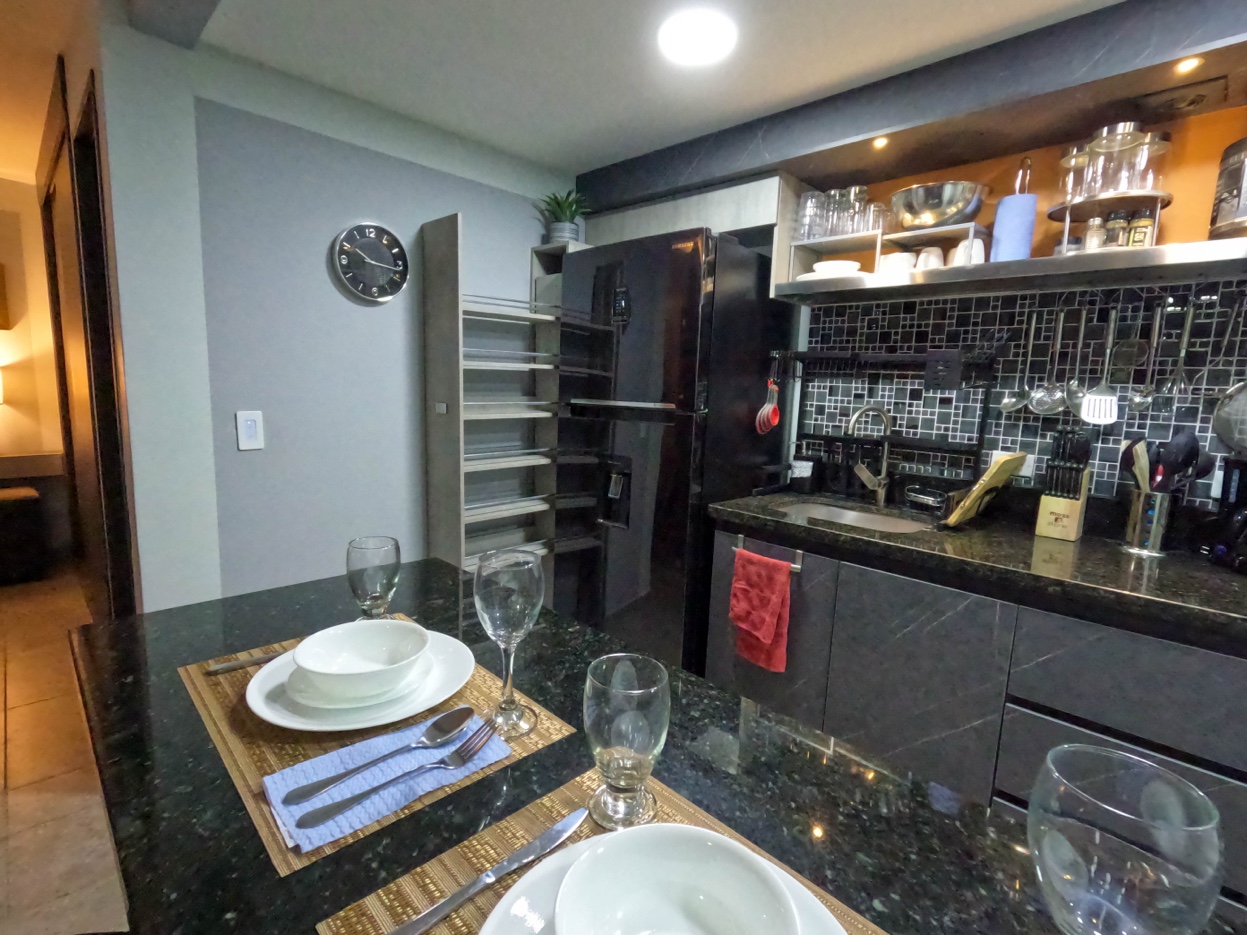 Kitchen granite bar peninsula at Oasis Laureles
