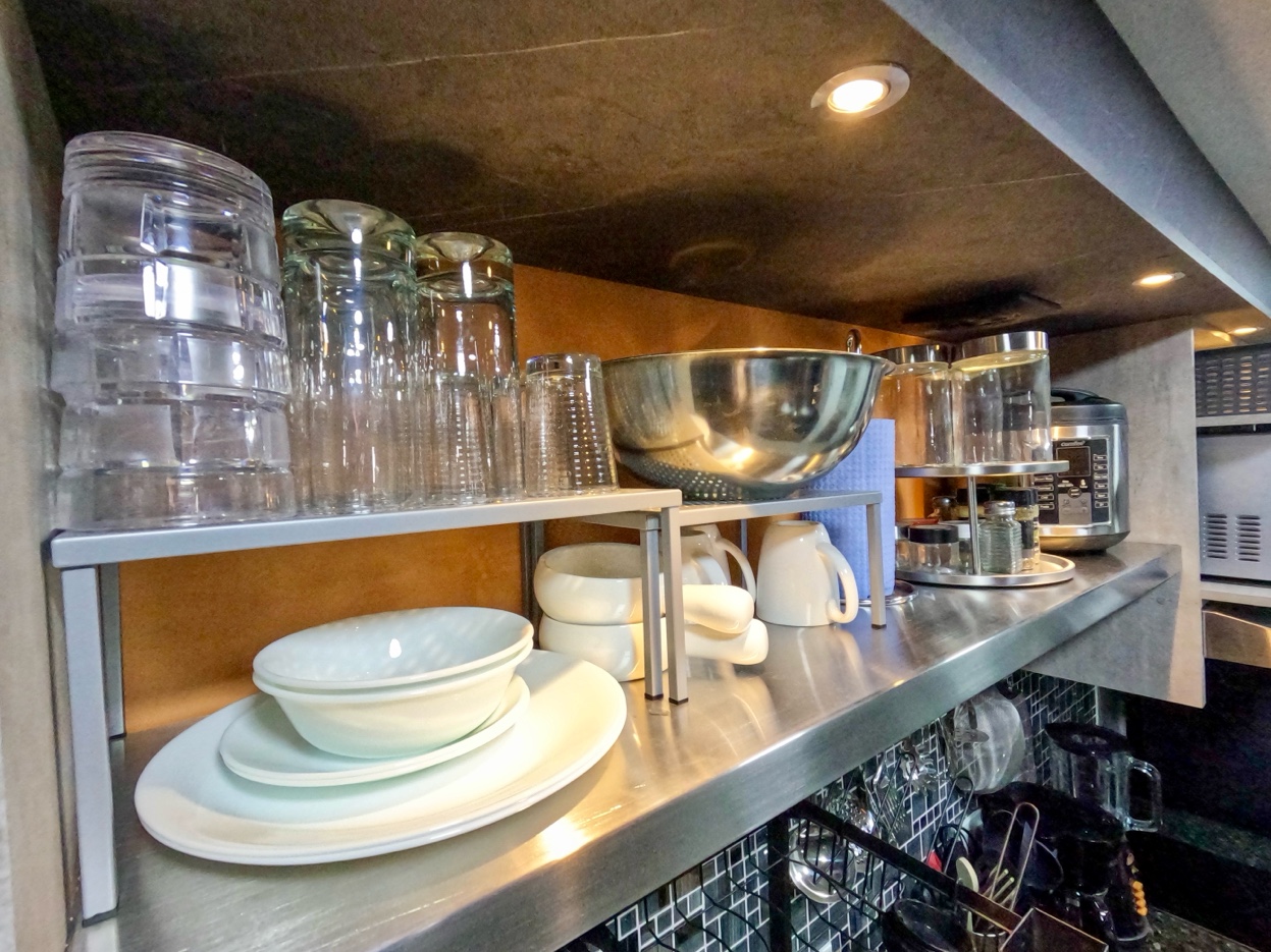 Kitchen shelving with glassware, dinnerware and cookware