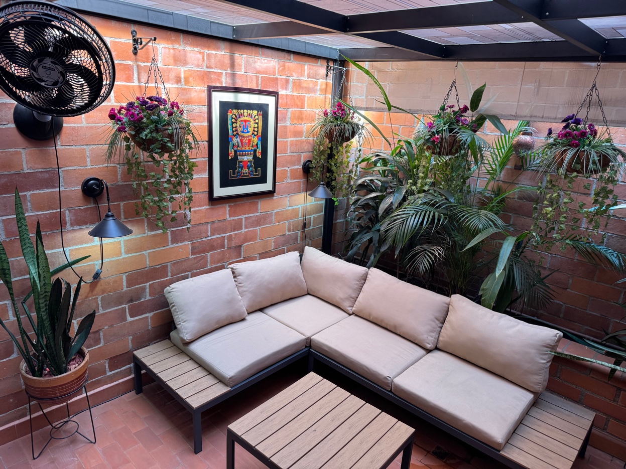 Terrace outdoor living room seating at Oasis Laureles